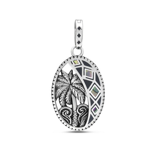 23mm x16mm oval sterling silver pendant with palm tree with black and irridescent diamond pattern along the side front.