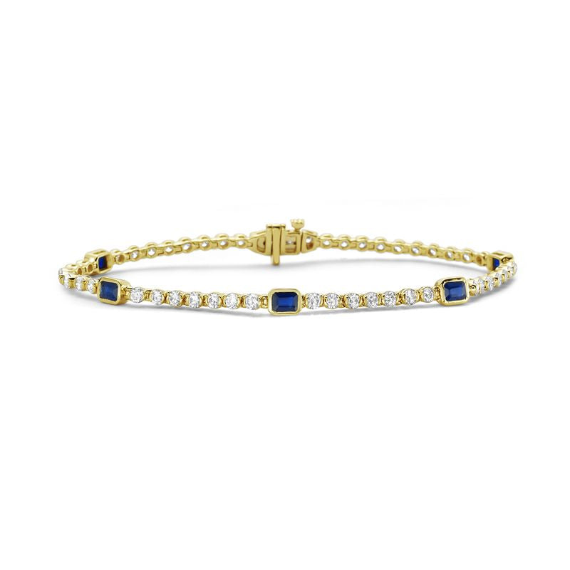 14KY 7 inch bracelet with 48 round diamonds 2.23ct tw and 5 emerald cut sapphires 1.23ct tw 4.4